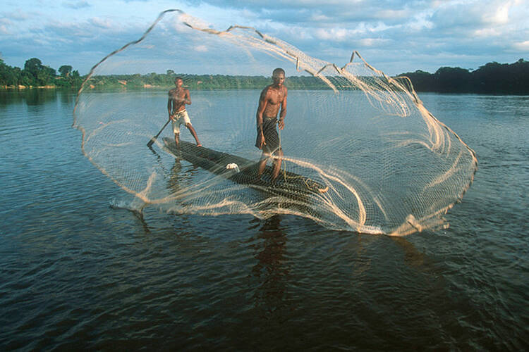  Fishermen with cast net fishing on the Dzanga River. Central African Republic. 